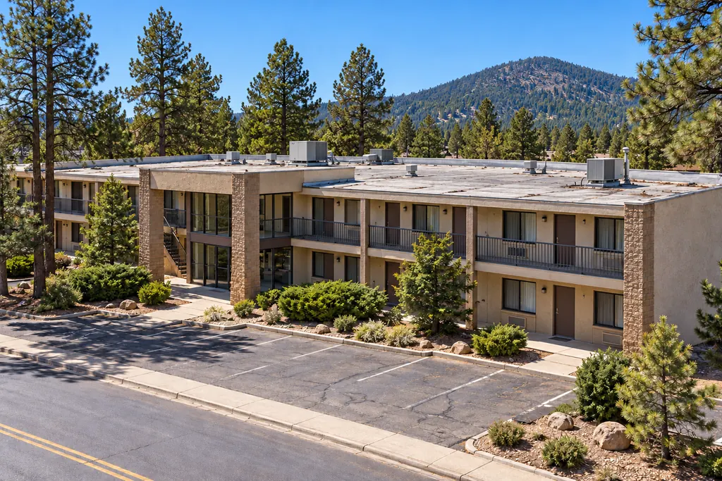 Two-story lodging building with a flat roof and rooftop equipment, typical of commercial buildings in Munds Park, AZ